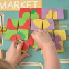 Excellerations® PlayGenius™ Community Helpers Wall Panel Market